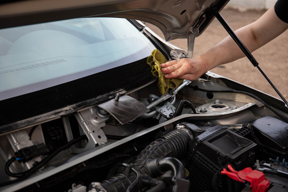 Mechanic replacing car windshield